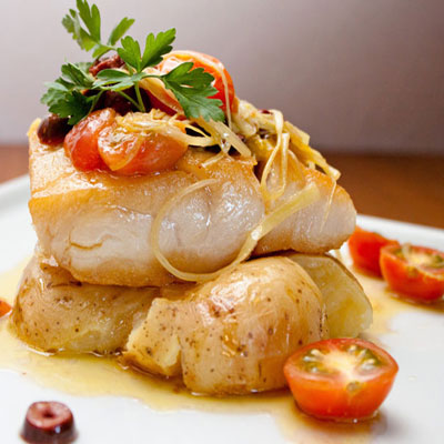 clos-up of a baked fish on a plate